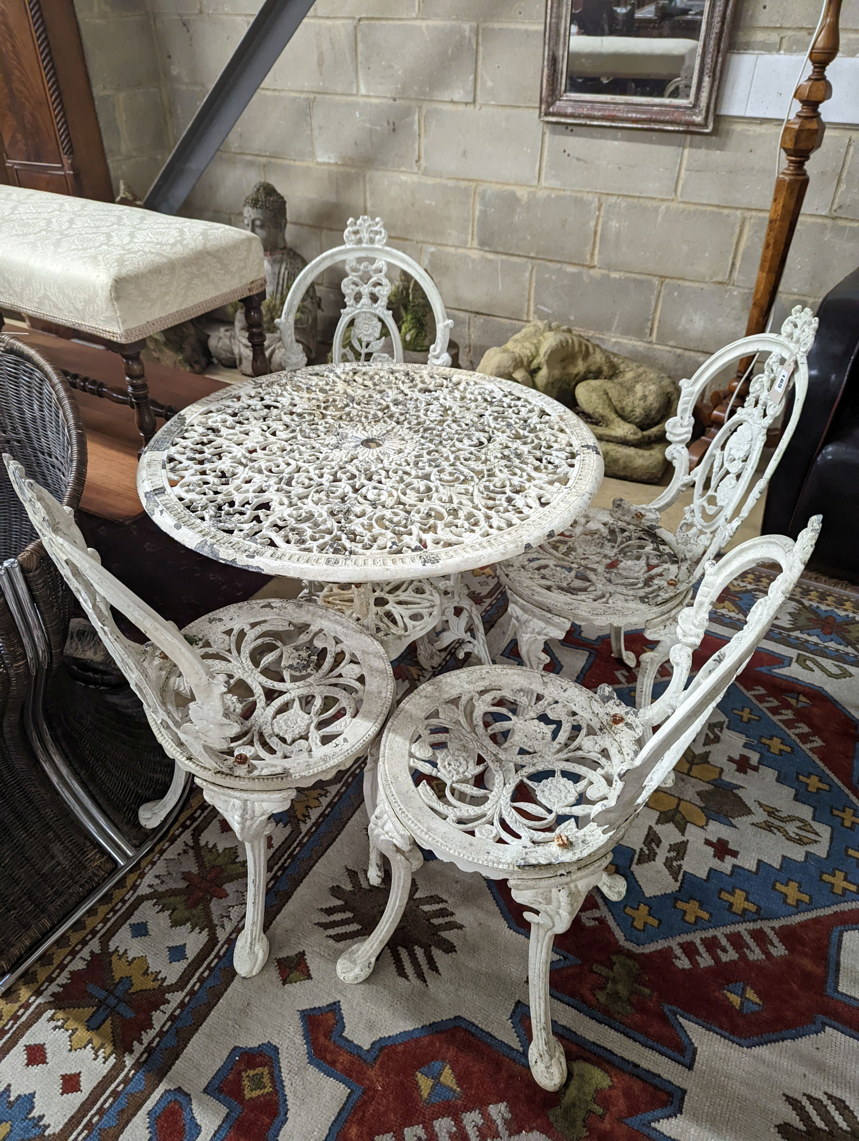 A Victorian style painted aluminium circular garden table, diameter 72cm, together with four chairs